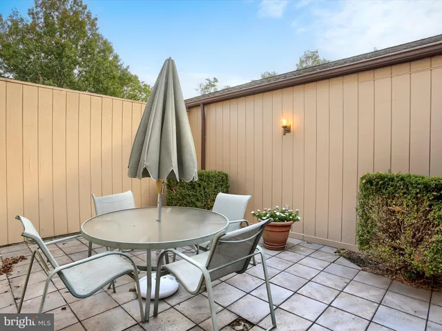 a backyard of a house with table and chairs