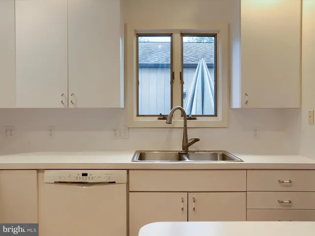 a bathroom with a sink and cabinets
