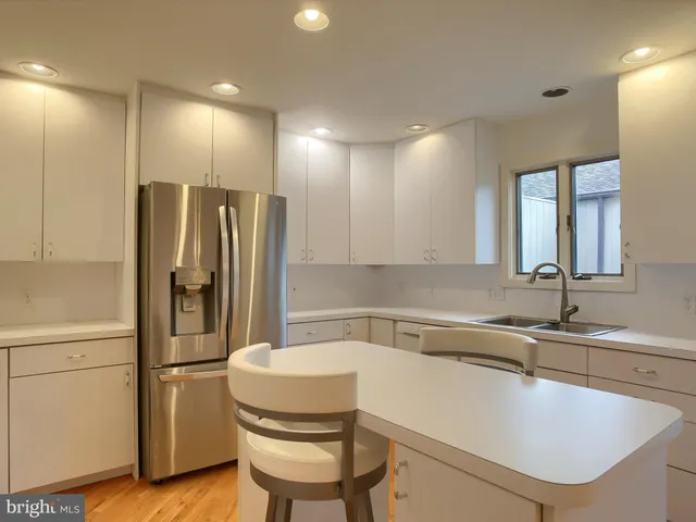 a kitchen with a refrigerator and a sink