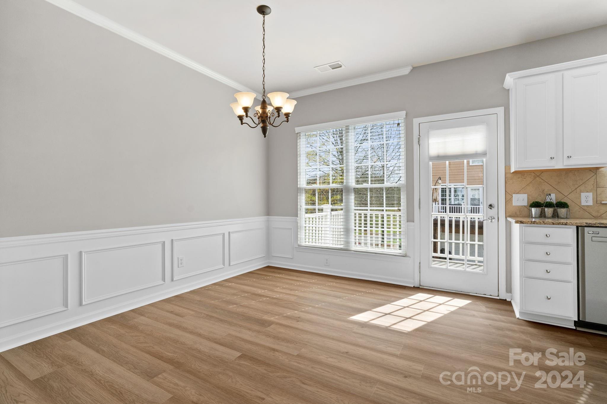 926 Lyndley Drive Fort Mill, SC 29708 - Photo 12 of 36 a view of an empty room with a window and wooden floor