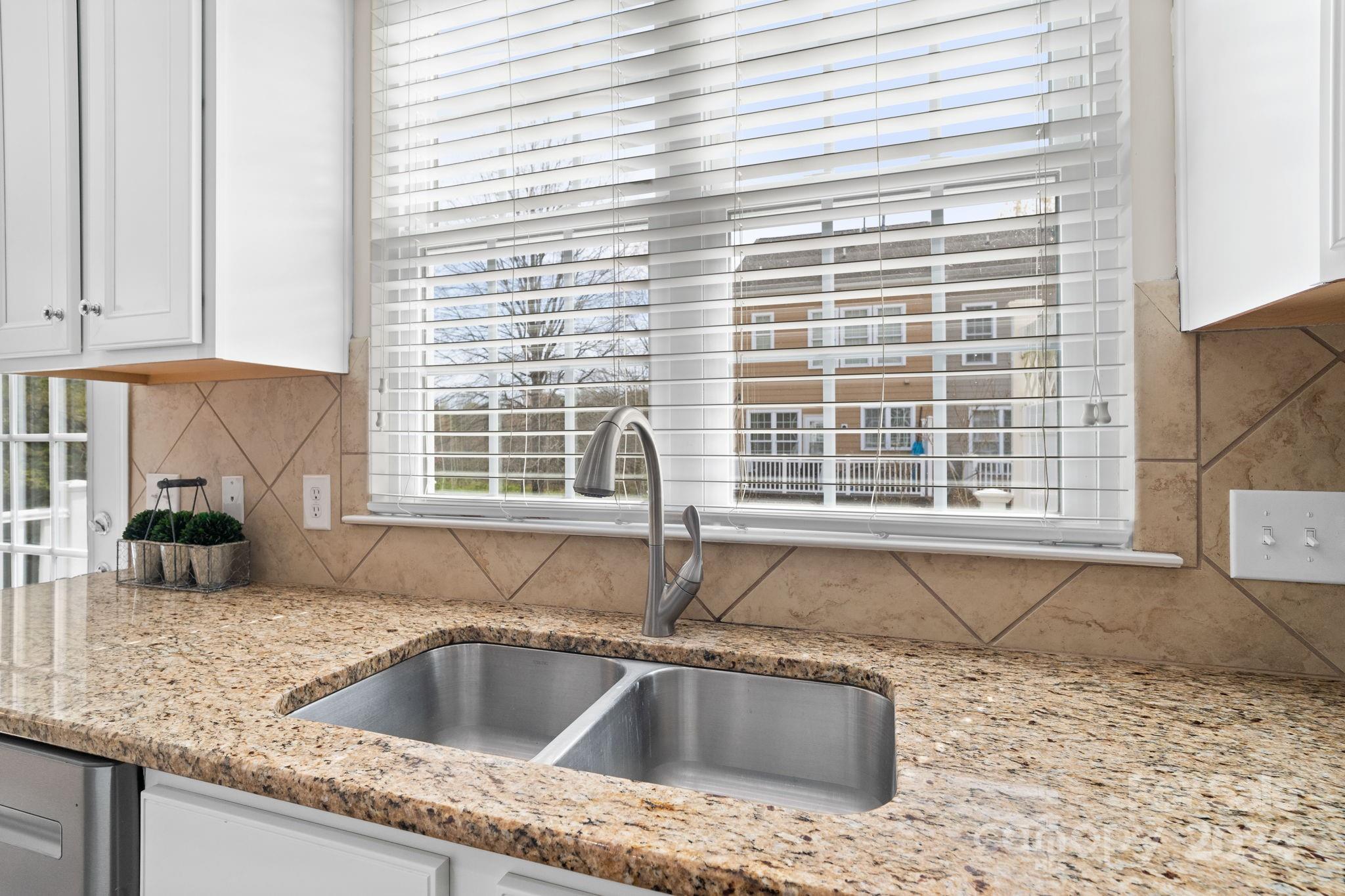 926 Lyndley Drive Fort Mill, SC 29708 - Photo 19 of 36 a kitchen with granite countertop a sink and a window