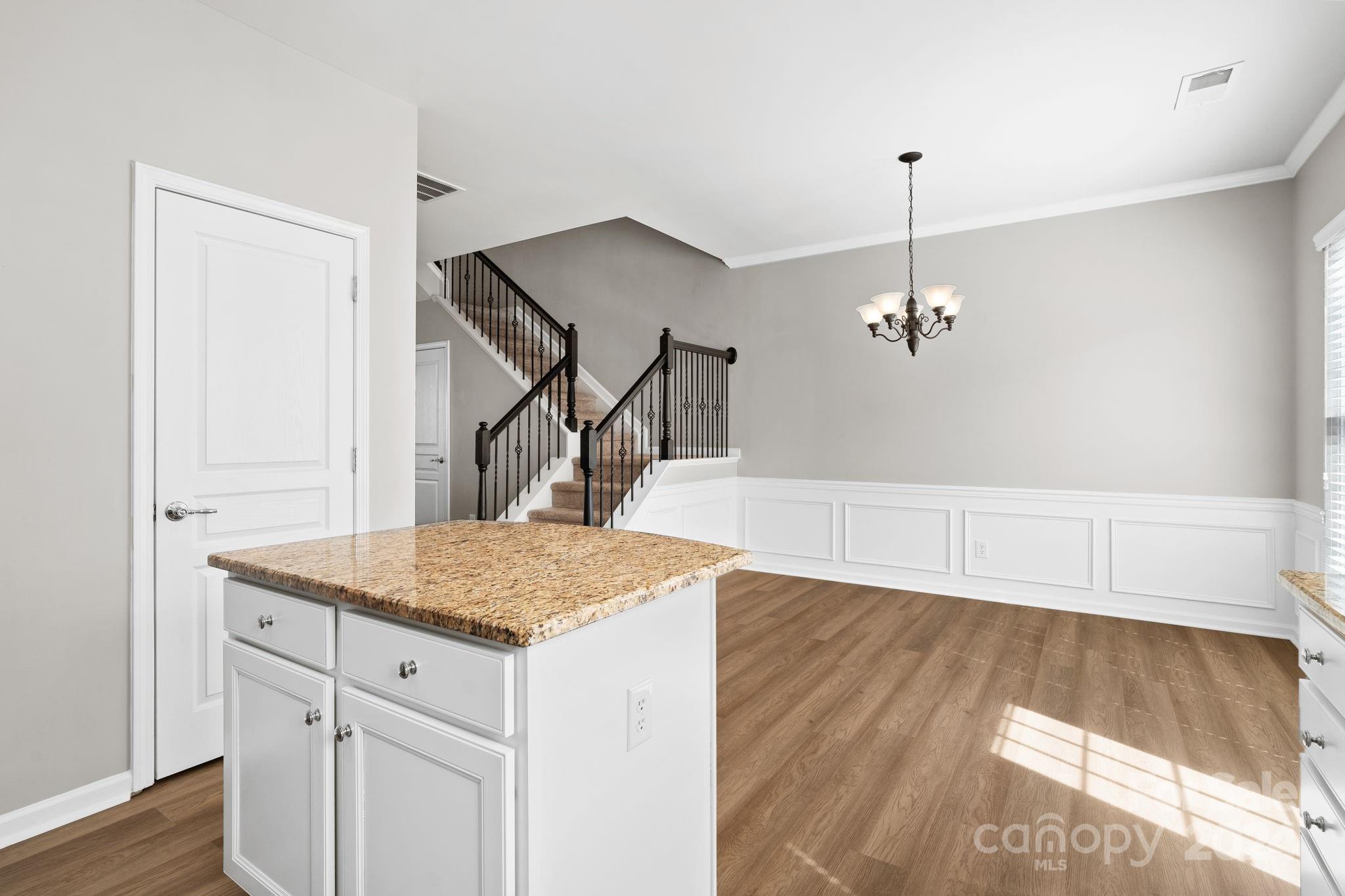 926 Lyndley Drive Fort Mill, SC 29708 - Photo 20 of 36 a kitchen with kitchen island cabinets and wooden floor