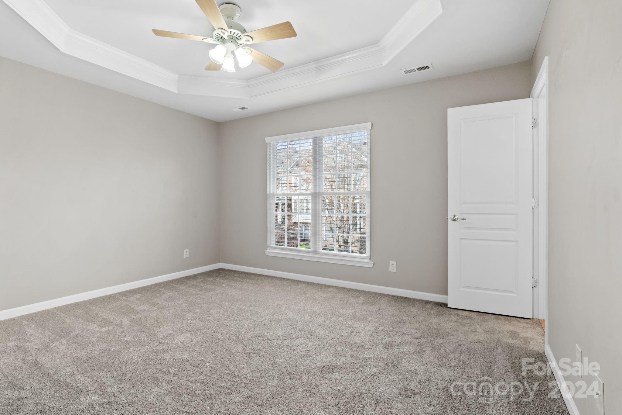 926 Lyndley Drive Fort Mill, SC 29708 - Photo 22 of 36 an empty room with chandelier fan and windows