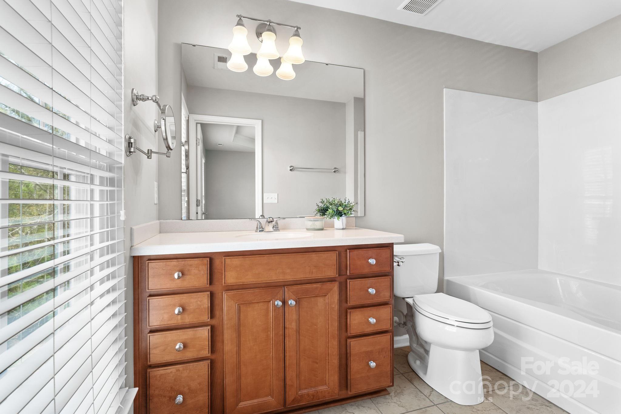 926 Lyndley Drive Fort Mill, SC 29708 - Photo 24 of 36 a bathroom with a toilet a sink and a bathtub