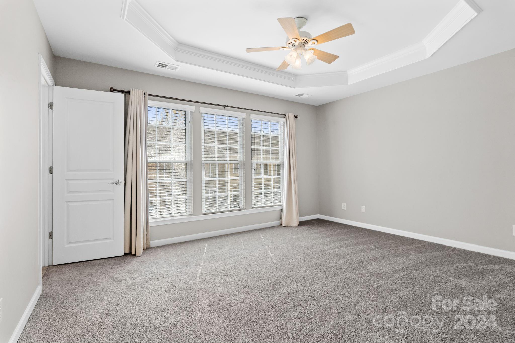 926 Lyndley Drive Fort Mill, SC 29708 - Photo 28 of 36 an empty room with chandelier fan and windows