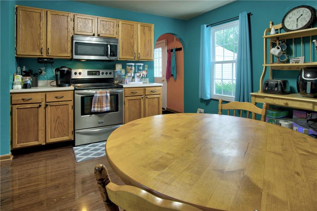 1029 Rural Ridge Drive Cheswick, PA 15024 - Photo 11 of 30 a kitchen with stainless steel appliances a stove a sink dishwasher and cabinets with wooden floor