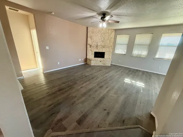 wooden floor in an empty room with a fireplace