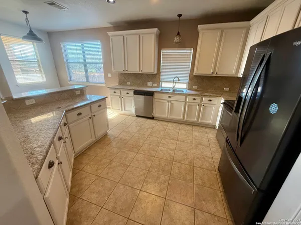 a kitchen with stainless steel appliances cabinets a sink and a window