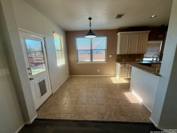 a view of a kitchen with a sink and dishwasher cabinets