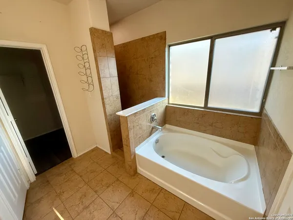 a bathroom with a bathtub and a shower