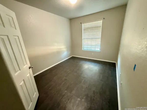 a view of room with window and hardwood floor