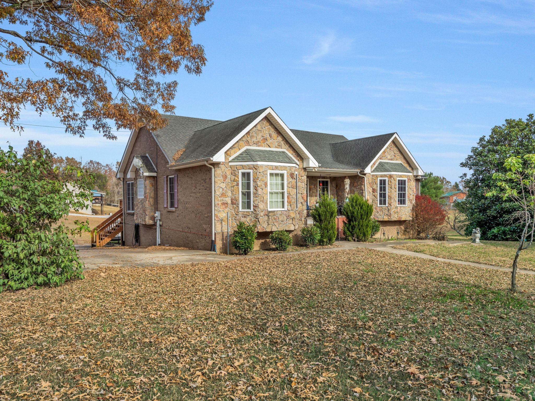 311 Downs Road Cumberland City, TN 37050 - Photo 7 of 30 a front view of a house with a garden