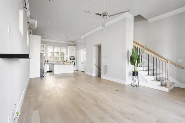 a view of large kitchen with wooden floor and windows