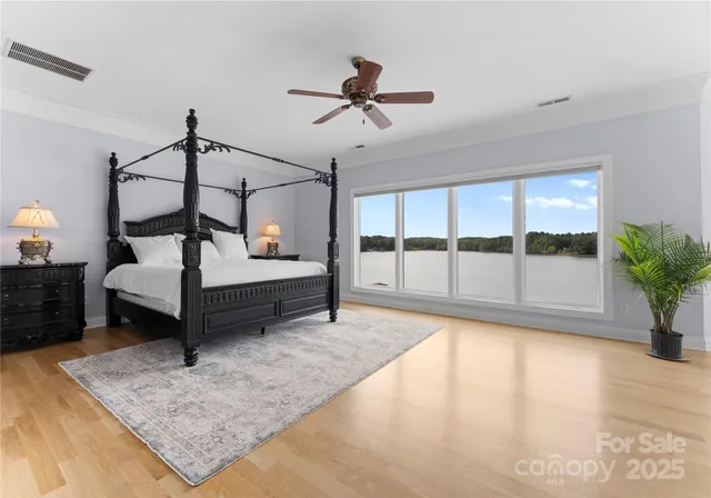 a open kitchen with white cabinets a stove and a wooden floors