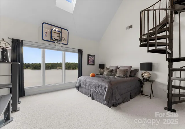 a spacious bedroom with a bed and a large window