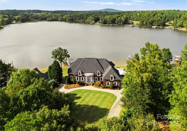 an aerial view of a house with a lake view