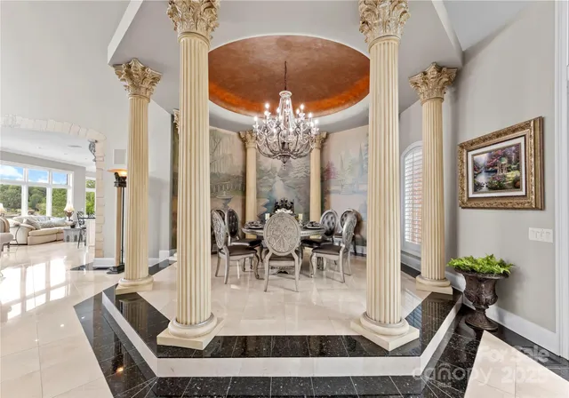 a view of a dining room with furniture and a chandelier