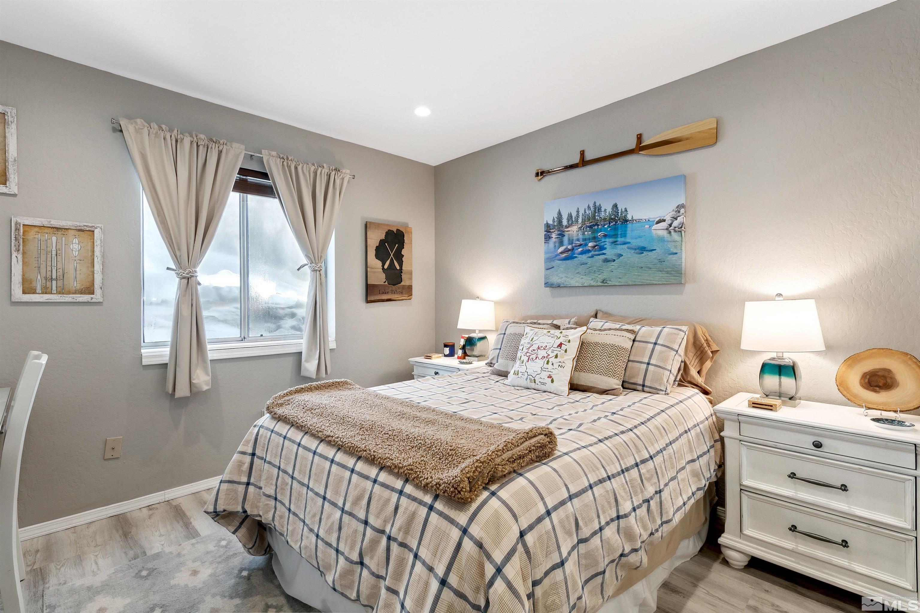 161 Tramway Drive, Unit A Stateline, NV 89449 - Photo 12 of 28 a bedroom with a large bed and a window