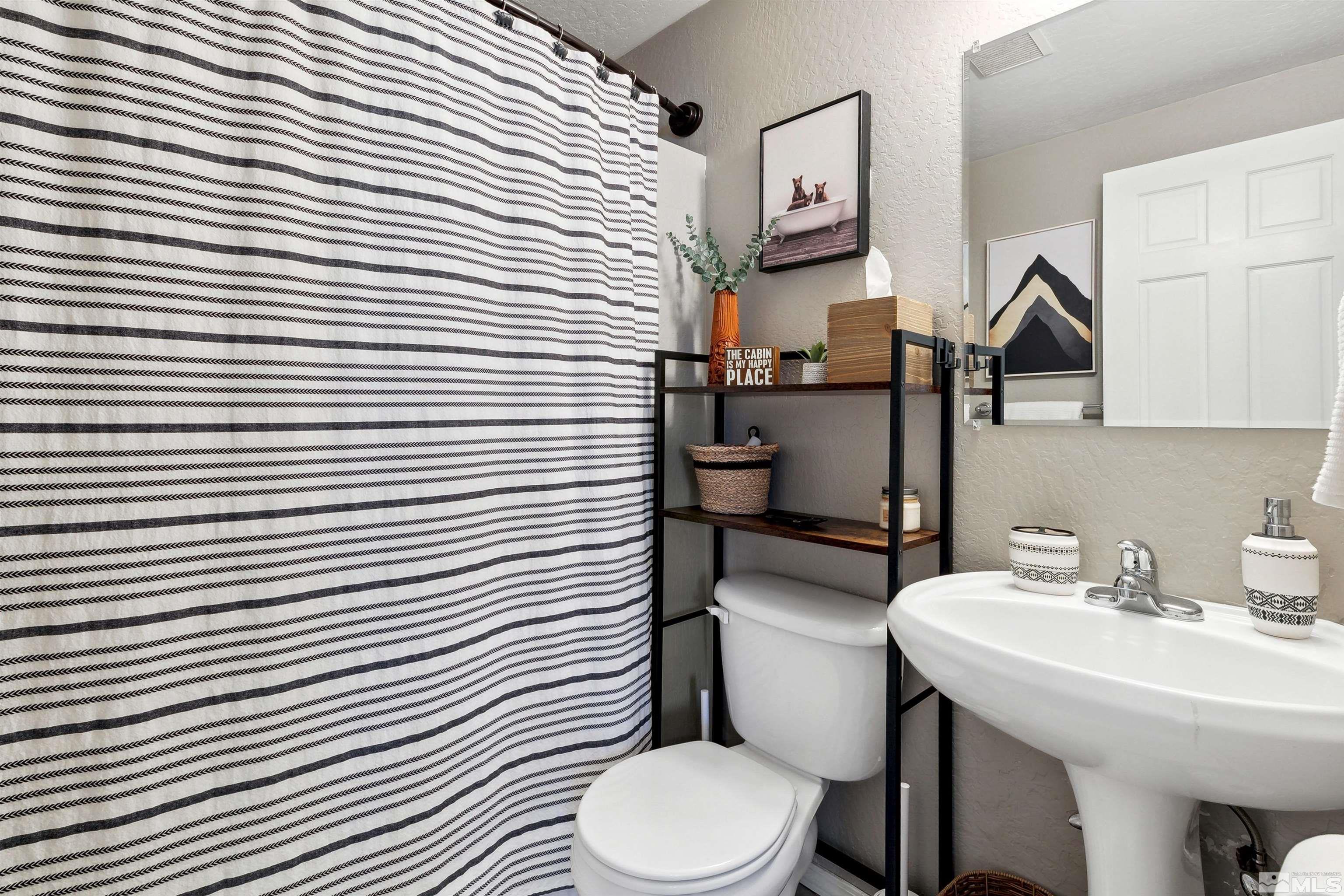 161 Tramway Drive, Unit A Stateline, NV 89449 - Photo 14 of 28 a bathroom with a toilet a sink and mirror