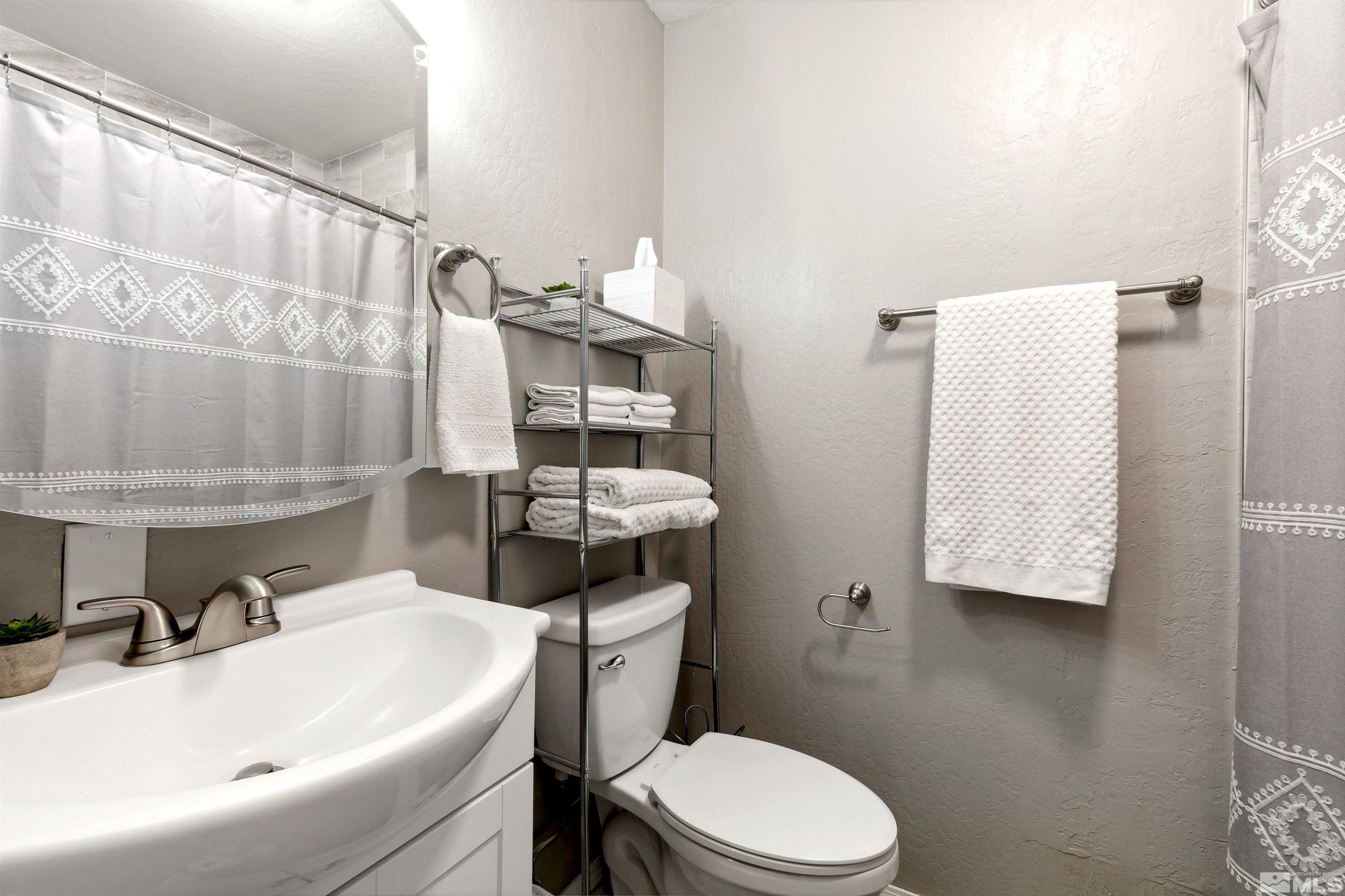 161 Tramway Drive, Unit A Stateline, NV 89449 - Photo 16 of 28 a white toilet sitting next to a bathroom sink
