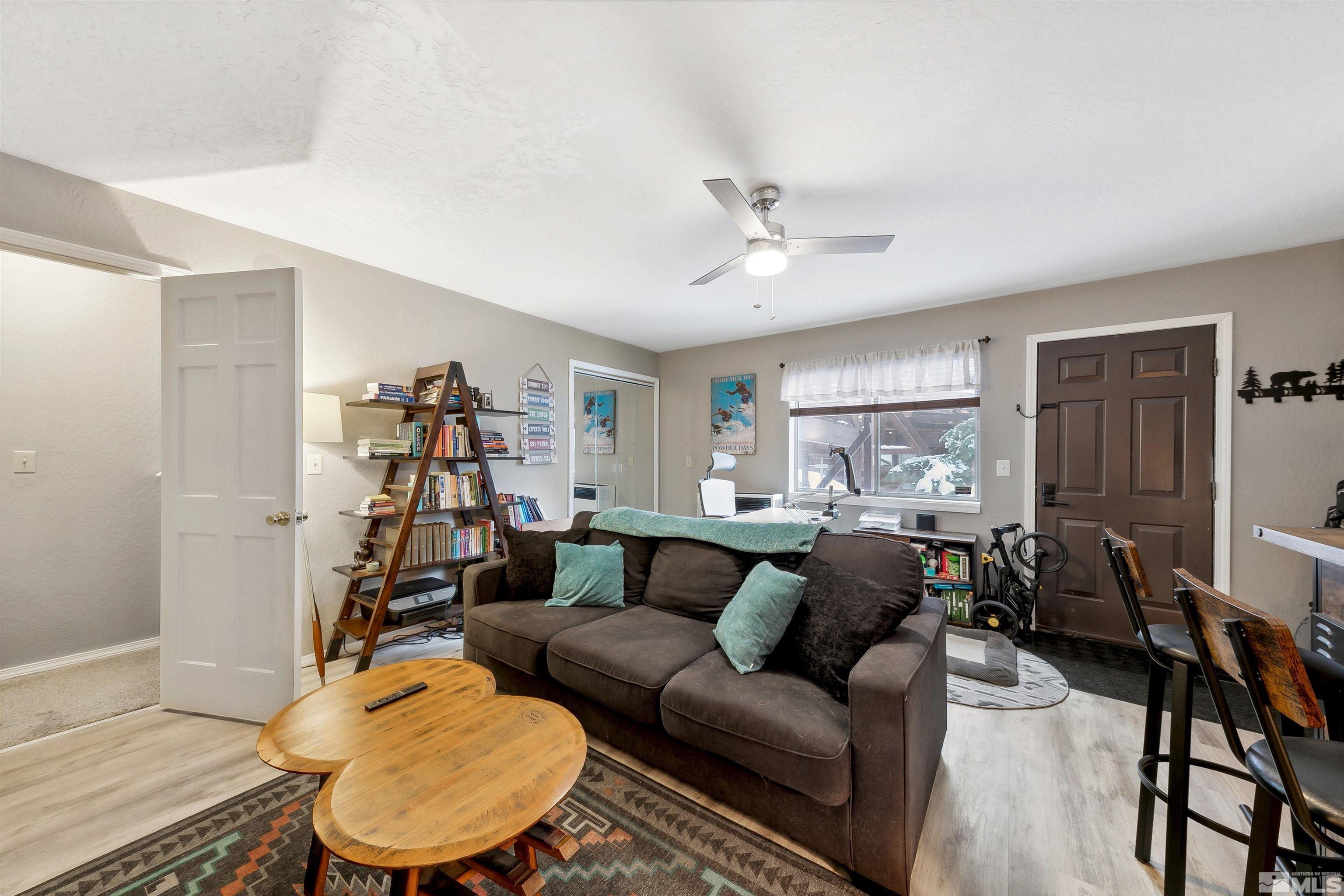 161 Tramway Drive, Unit A Stateline, NV 89449 - Photo 18 of 28 a living room with furniture a ceiling fan and a wooden floor