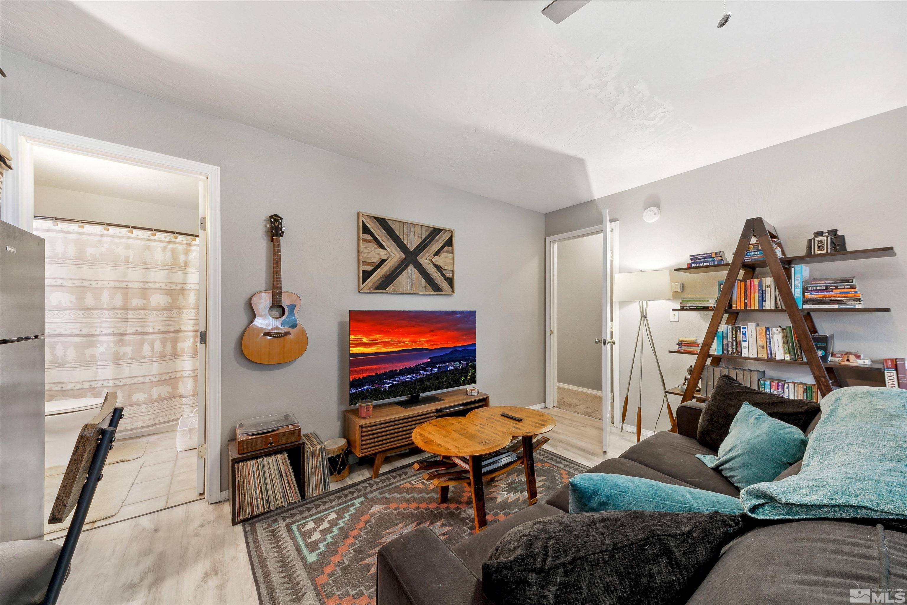 161 Tramway Drive, Unit A Stateline, NV 89449 - Photo 19 of 28 a living room with furniture a air conditioner and a window