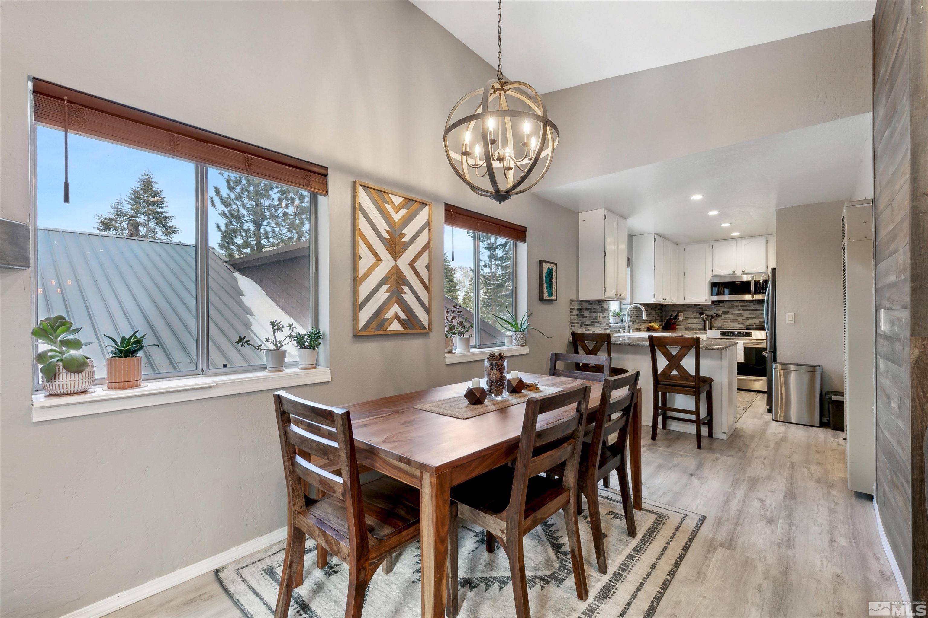 161 Tramway Drive, Unit A Stateline, NV 89449 - Photo 7 of 28 a view of a dining room with furniture window and wooden floor