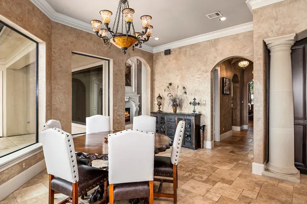 a dining room with furniture and a chandelier