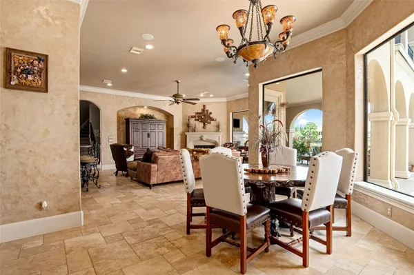 a living room with furniture a chandelier and a large window
