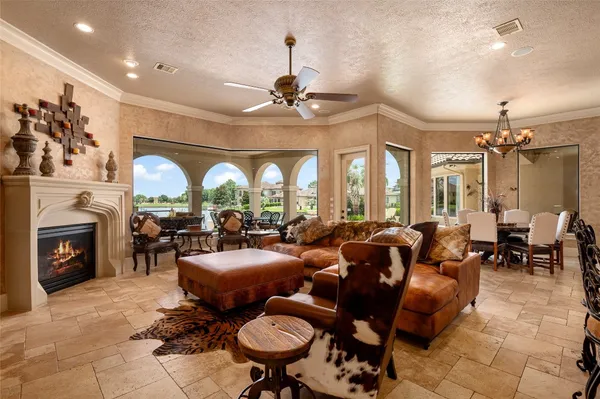 a living room with fireplace furniture and a chandelier