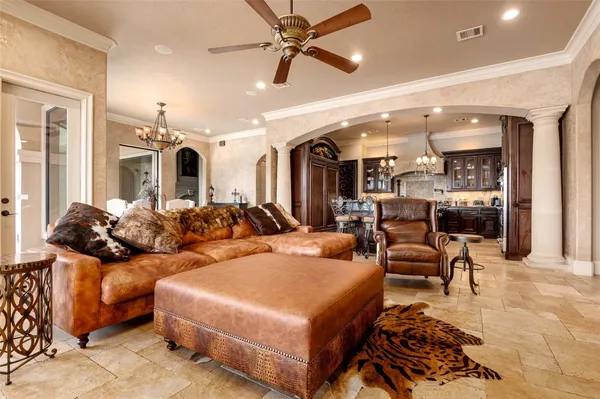 a living room with furniture and a view of kitchen