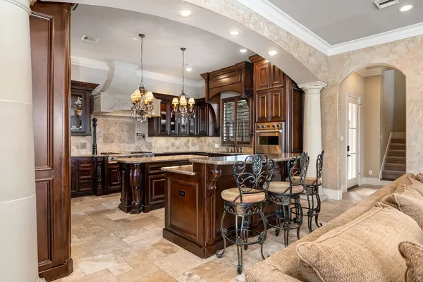 a large kitchen with a table and chairs