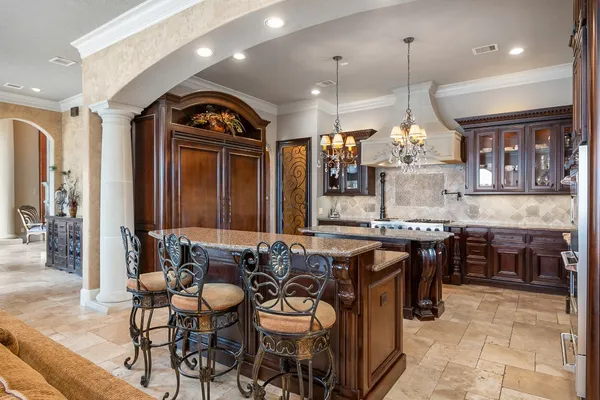 a large kitchen with a table and chairs