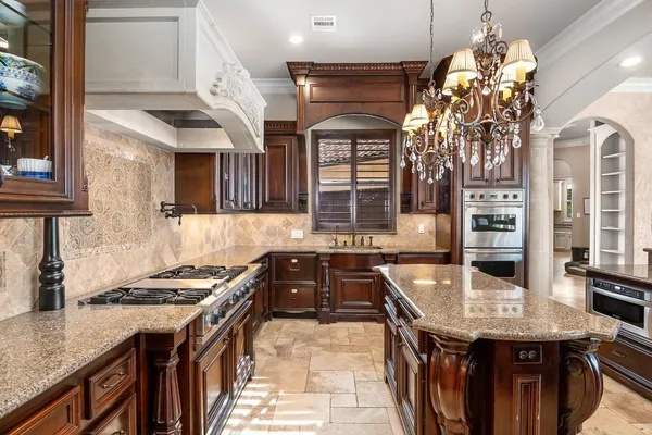 a kitchen with stainless steel appliances granite countertop a stove and a cabinets