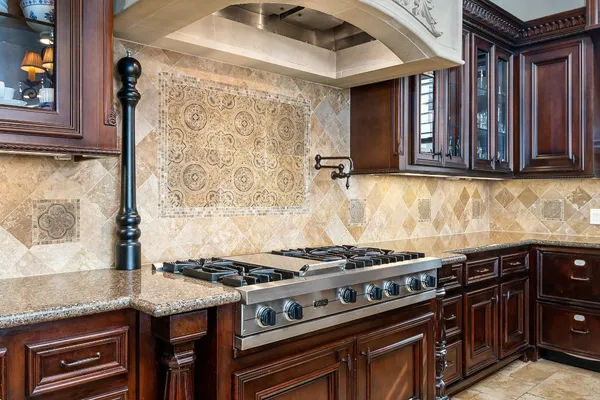 a kitchen with granite countertop a stove and a sink