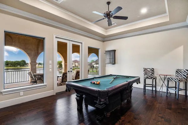 a living room with furniture pool table and a large window