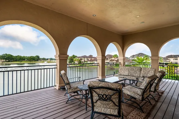 a view of a roof deck with couches and wooden floor