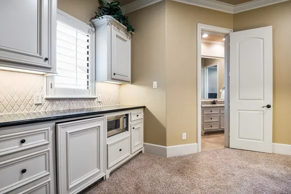 a kitchen with cabinets appliances and a window