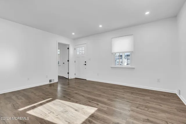 an empty room with wooden floor