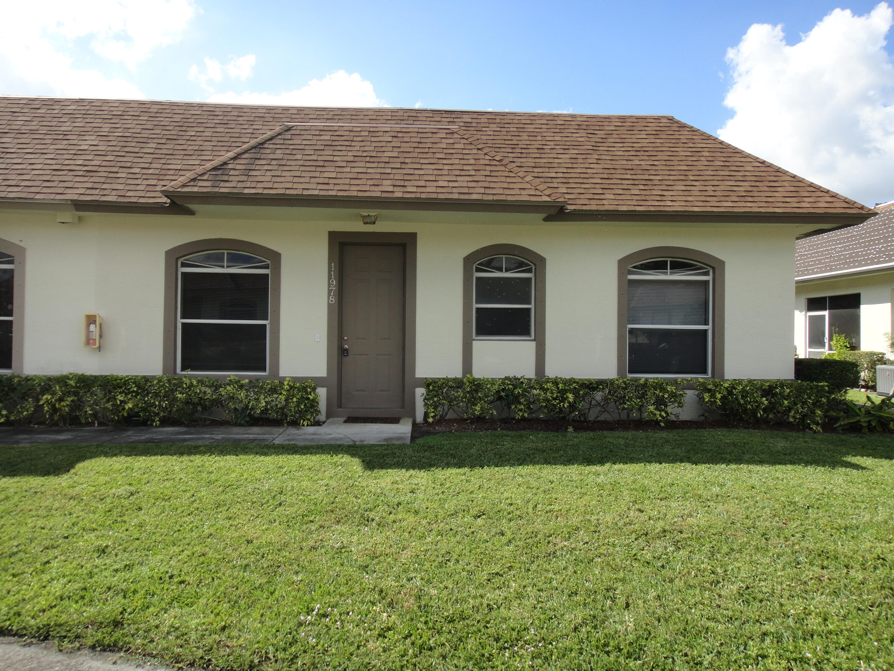 a front view of a house with a garden