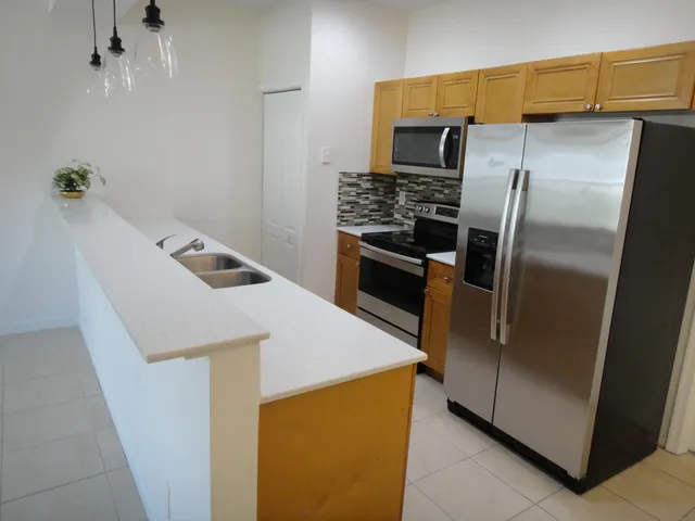 a kitchen with a refrigerator and a sink