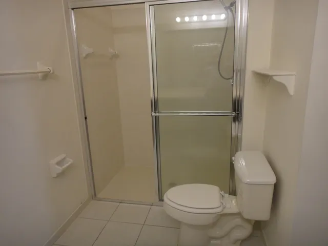 a bathroom with a toilet and a shower