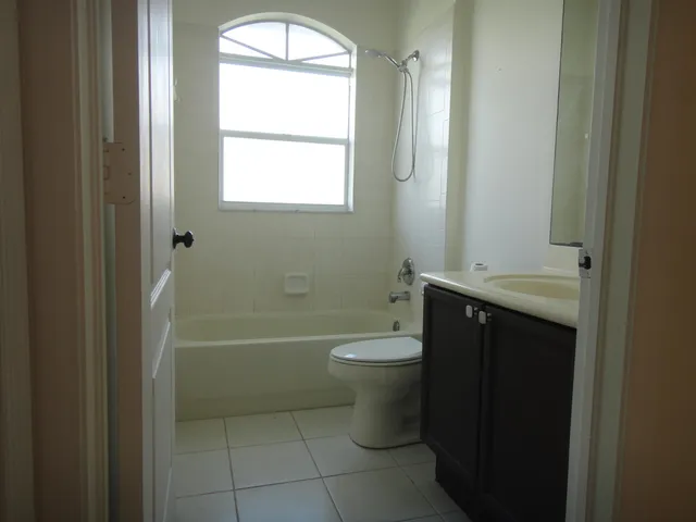 a bathroom with a toilet a sink and bathtub