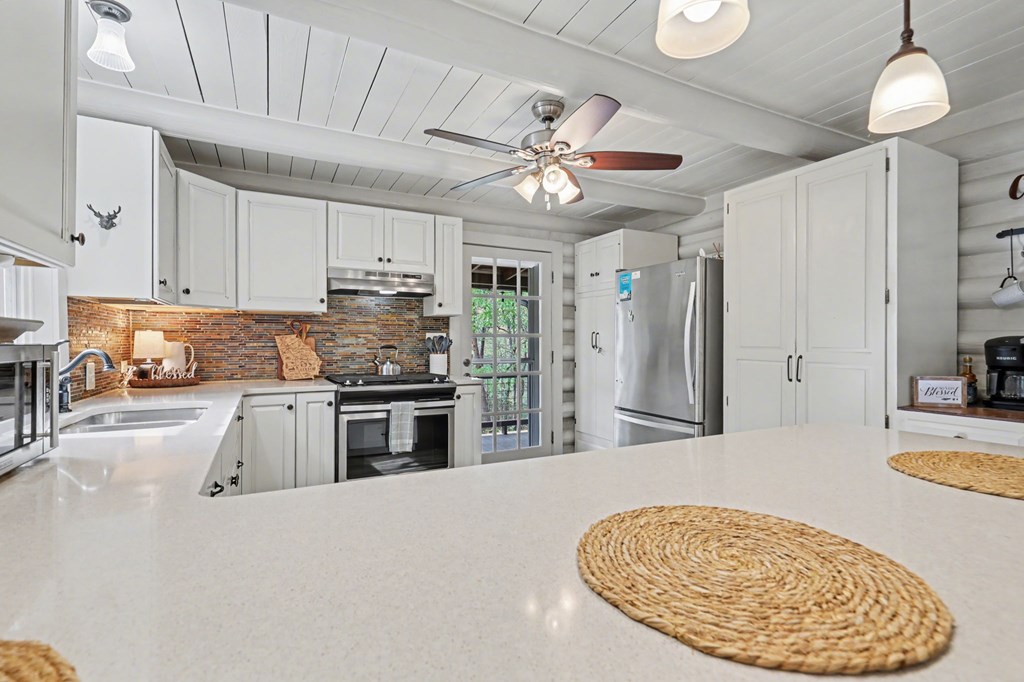 4609 Matheson Road Hiawassee, GA 30546 - Photo 13 of 57 a kitchen with stainless steel appliances granite countertop a sink a stove and a refrigerator
