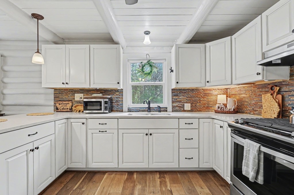 4609 Matheson Road Hiawassee, GA 30546 - Photo 14 of 57 a kitchen with white cabinets and white appliances