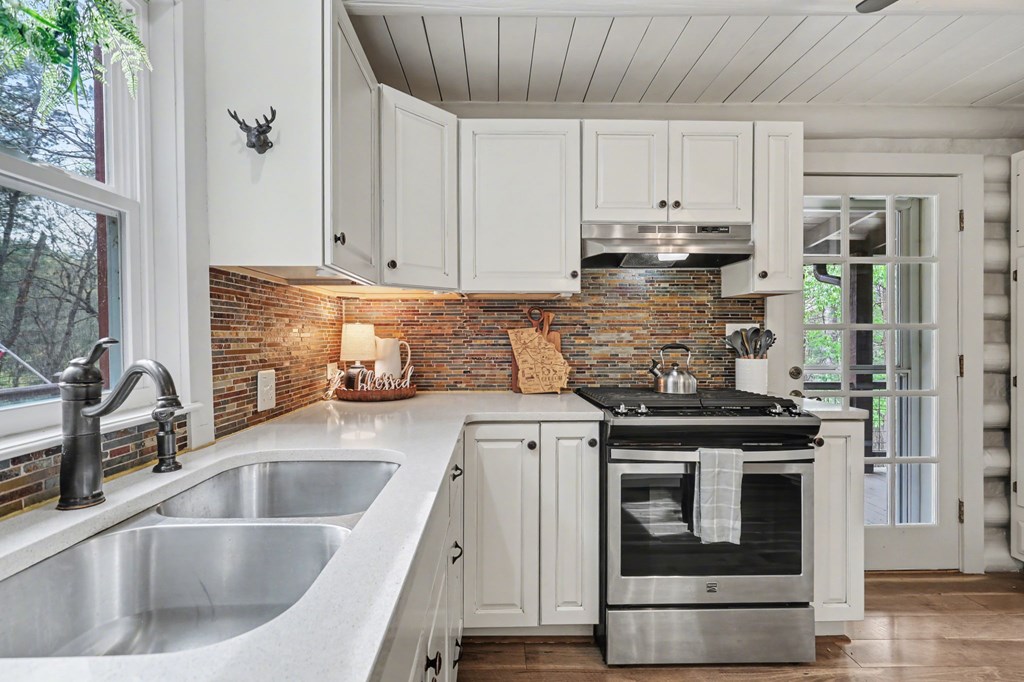 4609 Matheson Road Hiawassee, GA 30546 - Photo 15 of 57 a kitchen with granite countertop a sink stainless steel appliances and cabinets