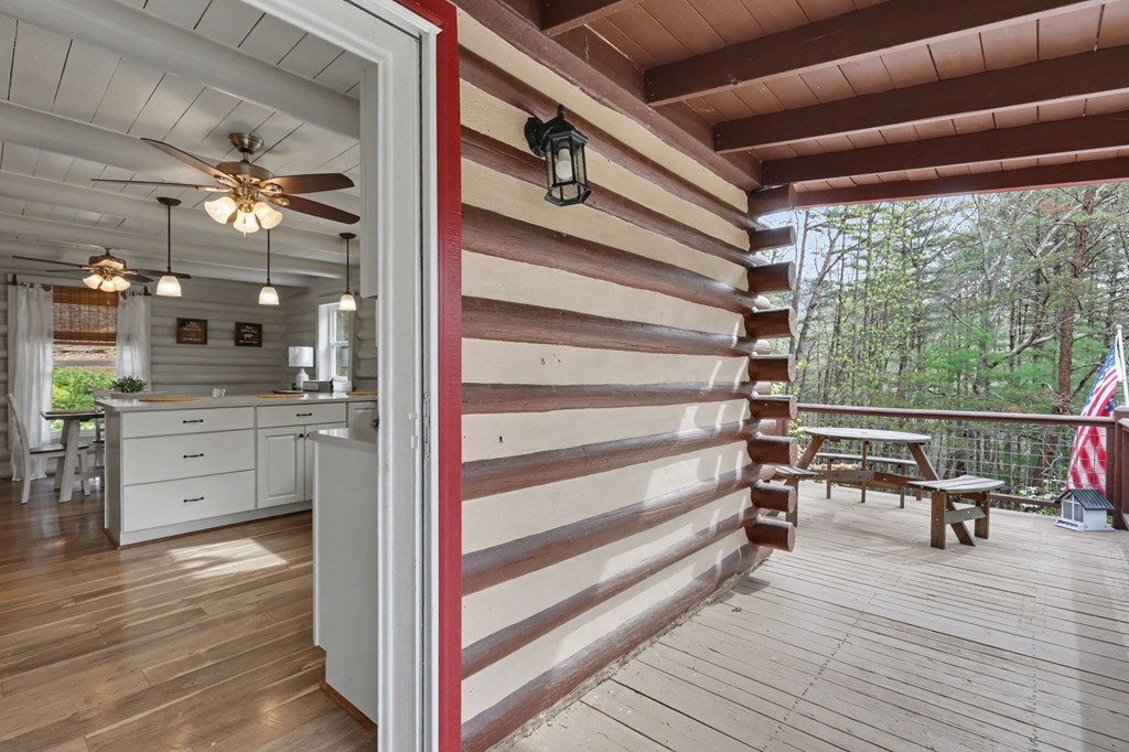 4609 Matheson Road Hiawassee, GA 30546 - Photo 16 of 57 a view of a balcony with chairs and wooden floor