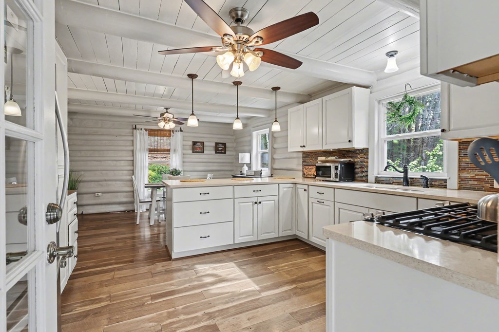 4609 Matheson Road Hiawassee, GA 30546 - Photo 19 of 57 a kitchen with cabinets wooden floor and a fireplace