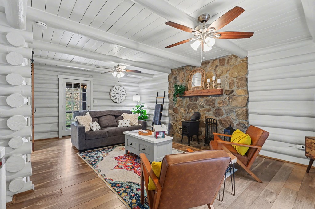 4609 Matheson Road Hiawassee, GA 30546 - Photo 22 of 57 a living room with furniture a fireplace and a chandelier