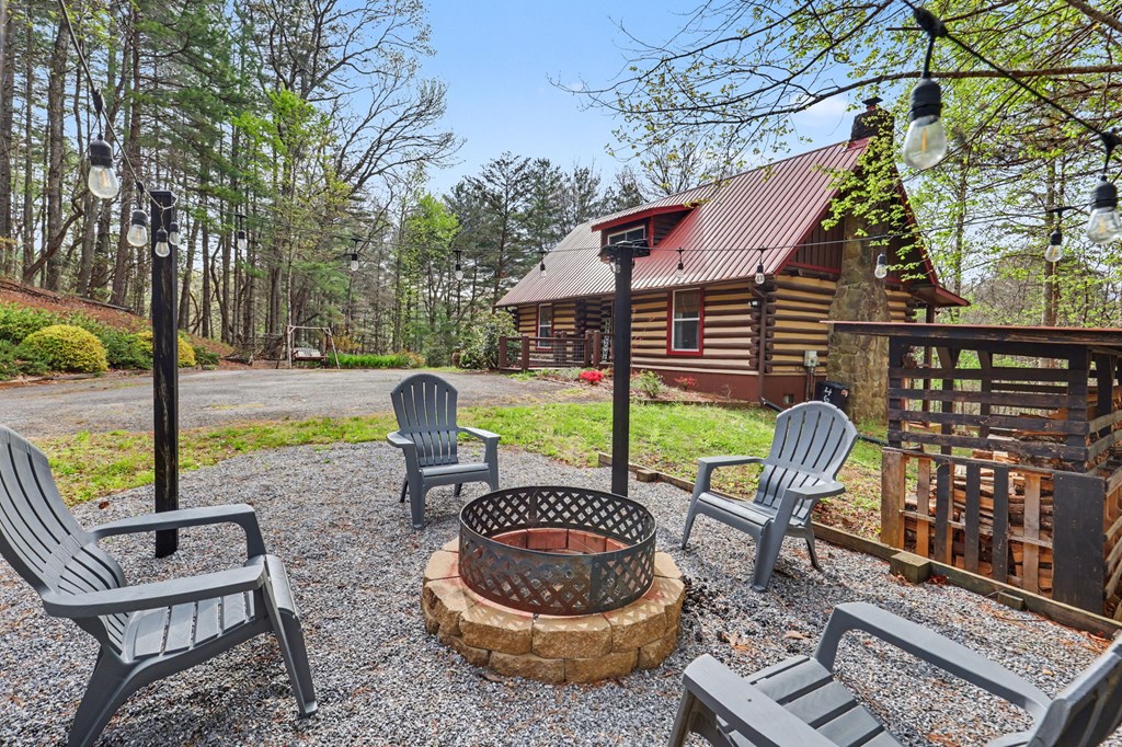 4609 Matheson Road Hiawassee, GA 30546 - Photo 3 of 57 a view of a chair and tables in the patio with a backyard